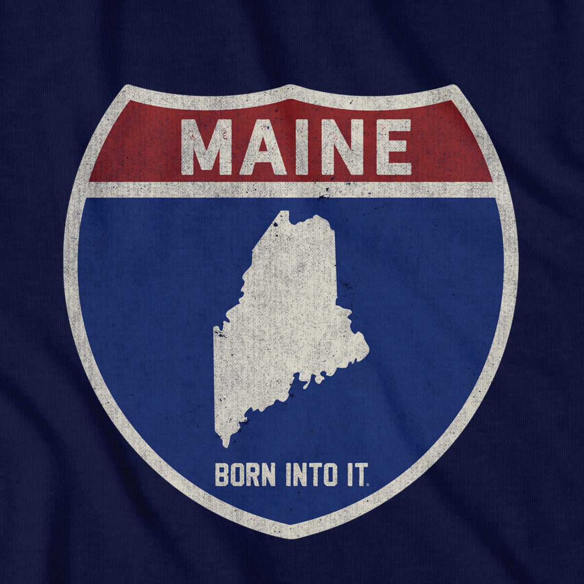 Born Into It Maine Interstate Sign T-Shirt featuring a graphic design of a highway sign with state initials and bold text.