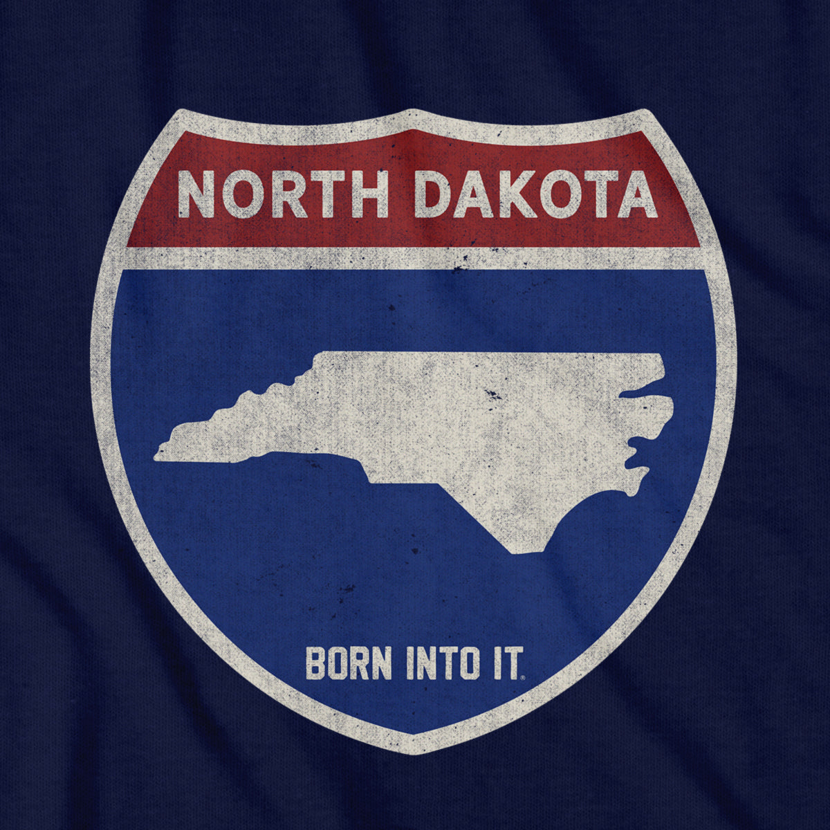 Born Into It North Dakota Interstate Sign T-Shirt featuring a graphic of the North Dakota highway sign on a casual cotton tee.